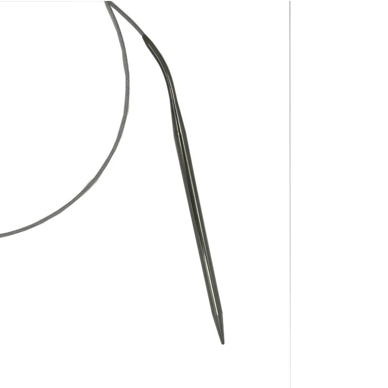 Circular knitting needles made of stainless steel lie on a knitted sweater, demonstrating their applicability