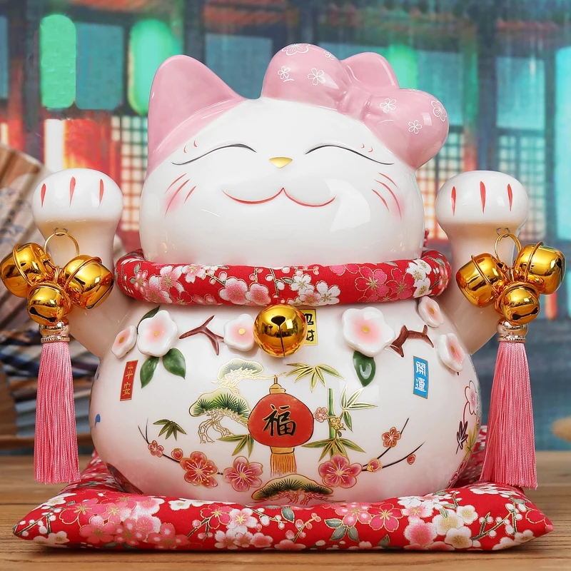 Ceramic figure of Maneki-neko Cat with raised paw on a white background