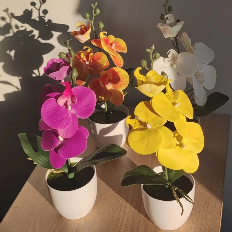 Artificial bonsai orchid standing on an office desk