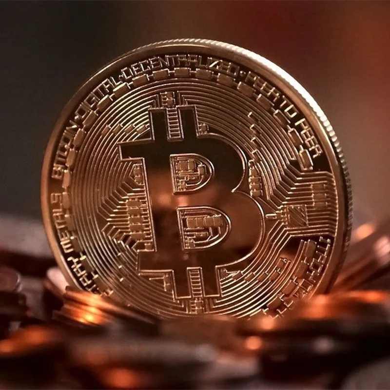 Bitcoin coin in gold finish reflects the light