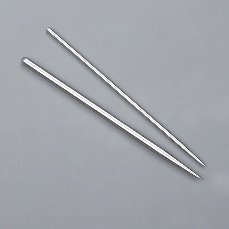 Human hand holding a ceramic set with steel tools