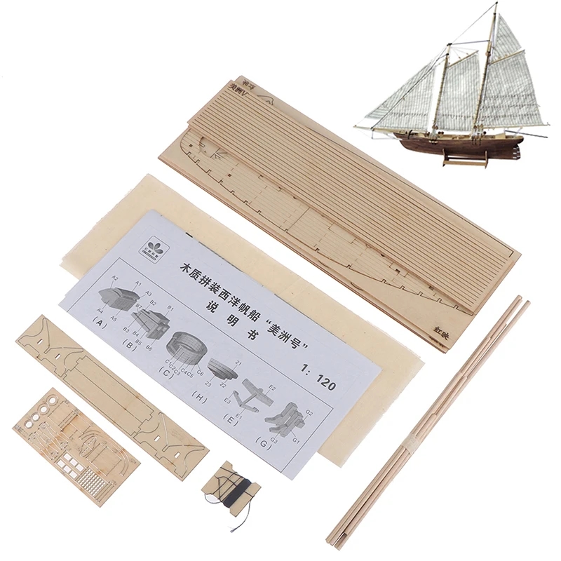 Wooden model of a sailing ship standing against a blue sky