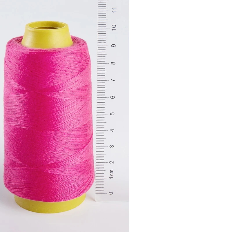 Spool of golden polyester sewing thread