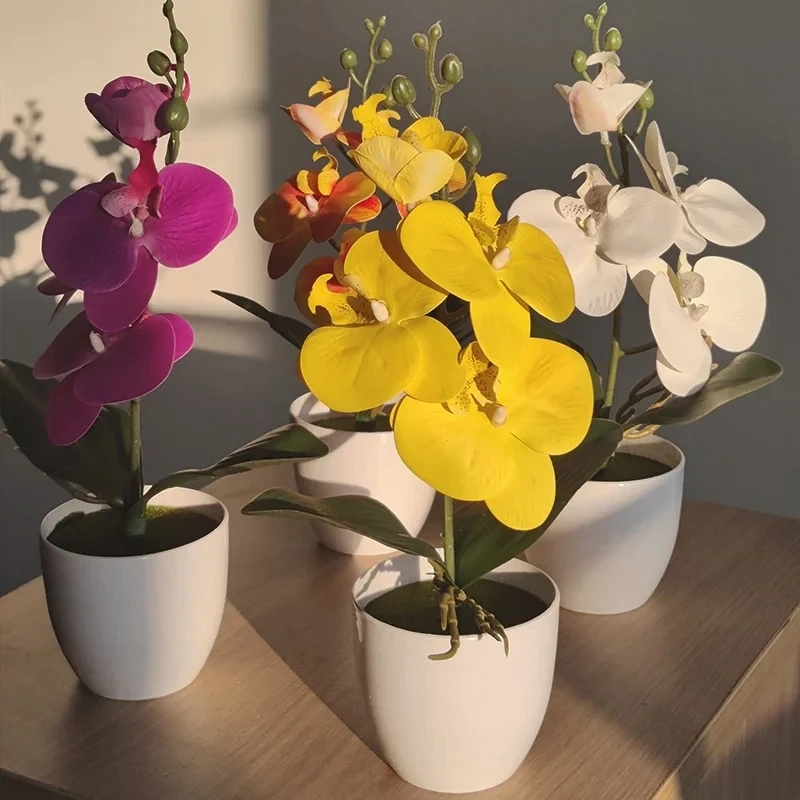 Artificial bonsai orchid in a ceramic pot on a wooden surface