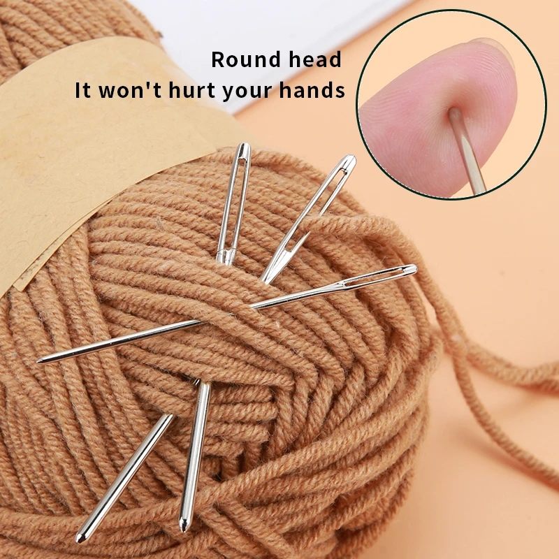 Craftswoman's hands holding several needles from the craft set