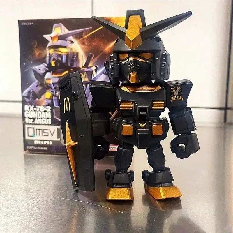 Image of human hands holding the Gundam McDonald's figurine