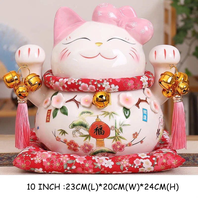 Three ceramic figures of Maneki-neko Cats of different sizes
