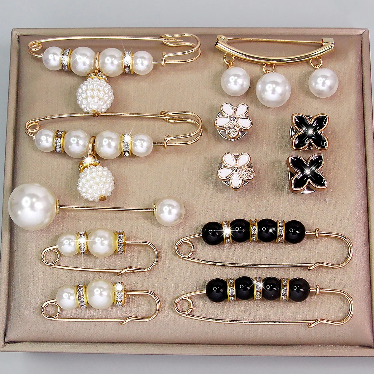 Elegant metal brooch with pearls in a geometric shape