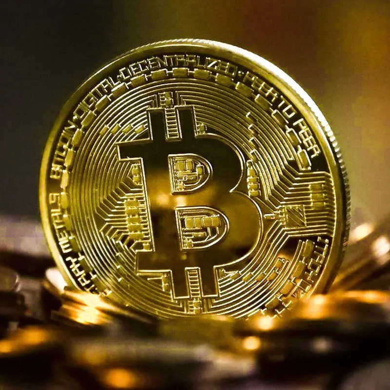 Close-up of the golden collectible Bitcoin coin with clear details