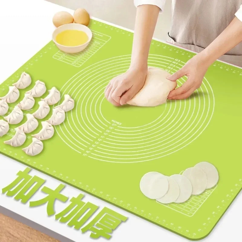 Baking mat with dough and kitchen utensils
