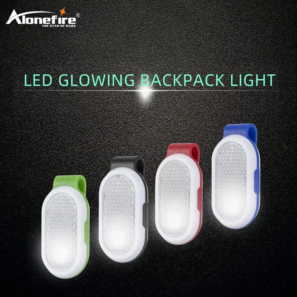 Clip-on flashlight for running or camping with red flashing lights on a dark background