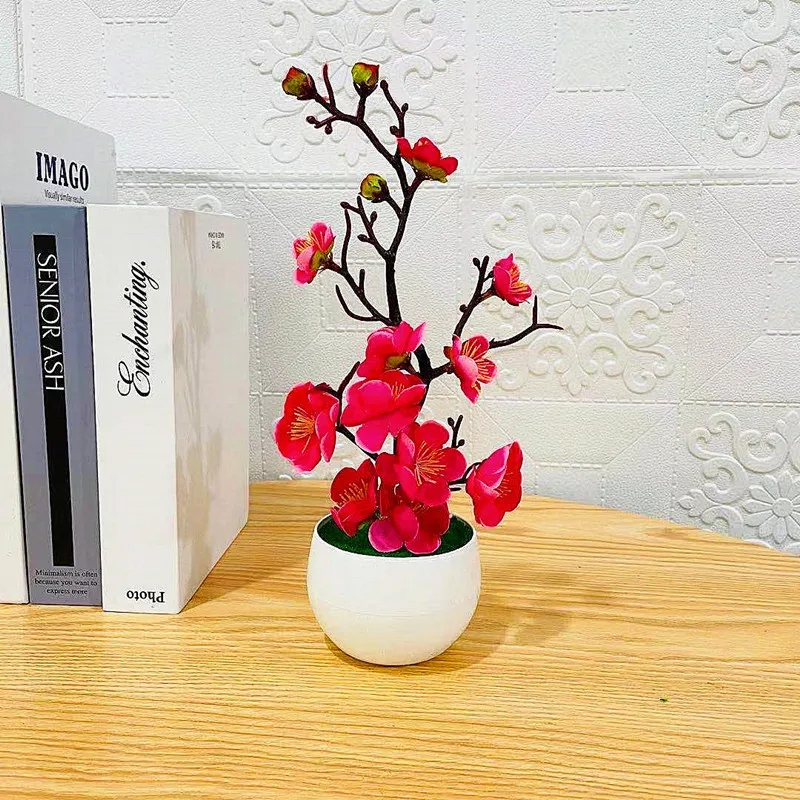 Small artificial bonsai plant with white flowers, decorating the interior