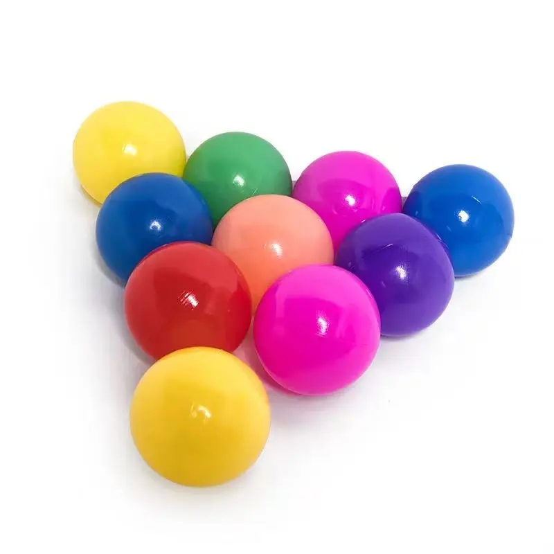 A dry ball pit filled with bright plastic balls of various colors