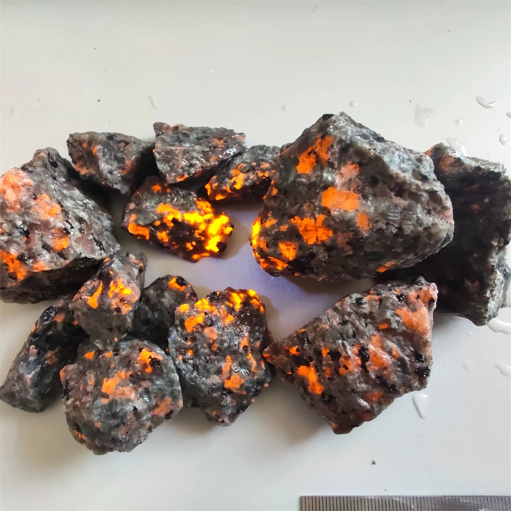 Natural Yooperlites stone with bright glow under UV light, showcasing unique texture and color
