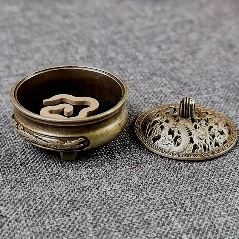 Compact size of the bronze incense burner compared to the palm of the hand