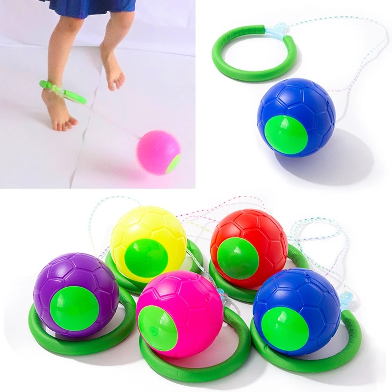 A girl jumping enthusiastically on a bright play ball
