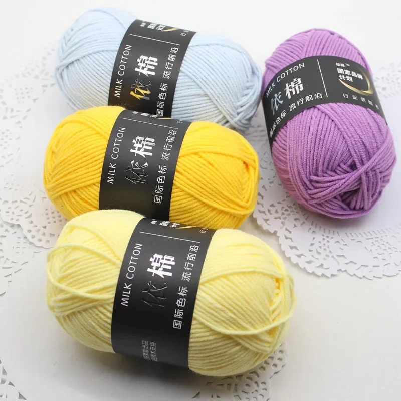 Several yarn balls of different colors lying on the surface