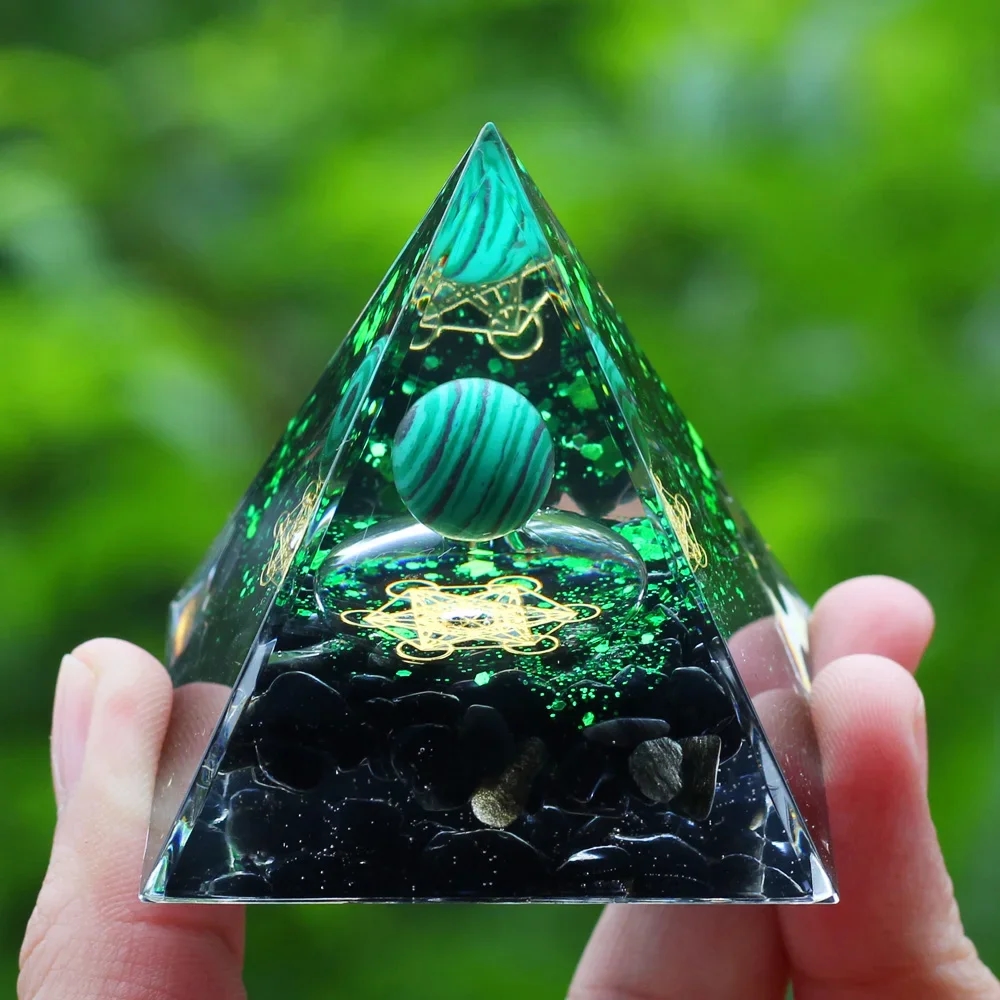 Aesthetic crystal pyramid made of natural stones with gold inclusions, looks beautiful on a shelf and creates an atmosphere of harmony