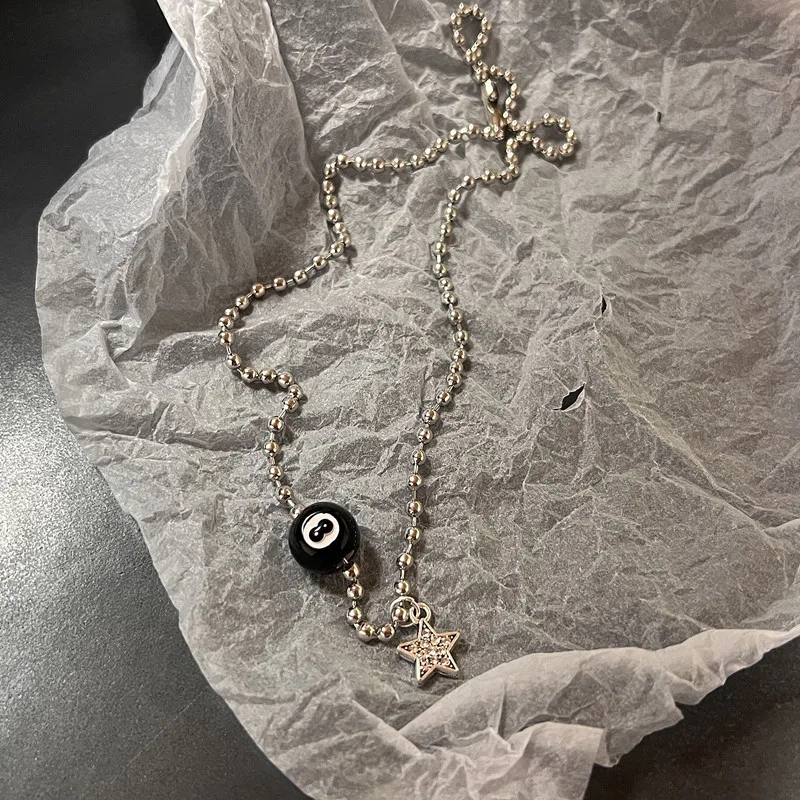 A woman's hand demonstrating the leather cord with star-shaped pendant