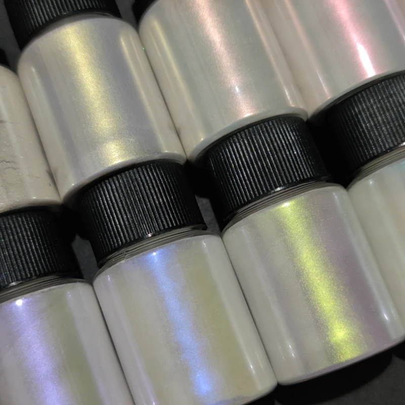 Close-up of a jar with blue pearlescent pigment
