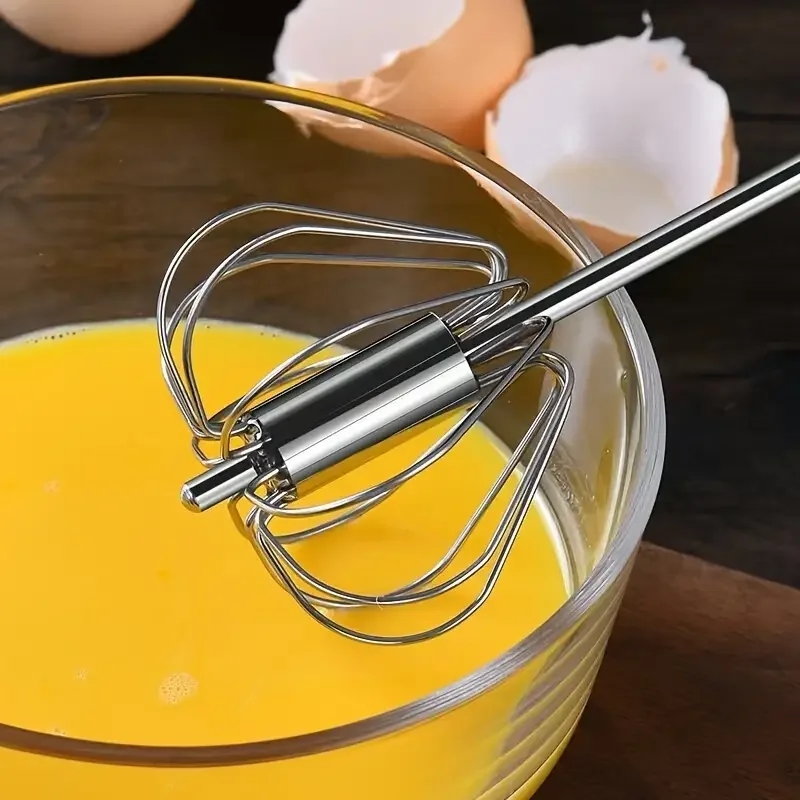 Stainless steel whisk against a backdrop of baking ingredients