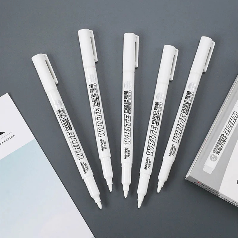 Various items on which the white marker can be used, including leather, fabric and wood