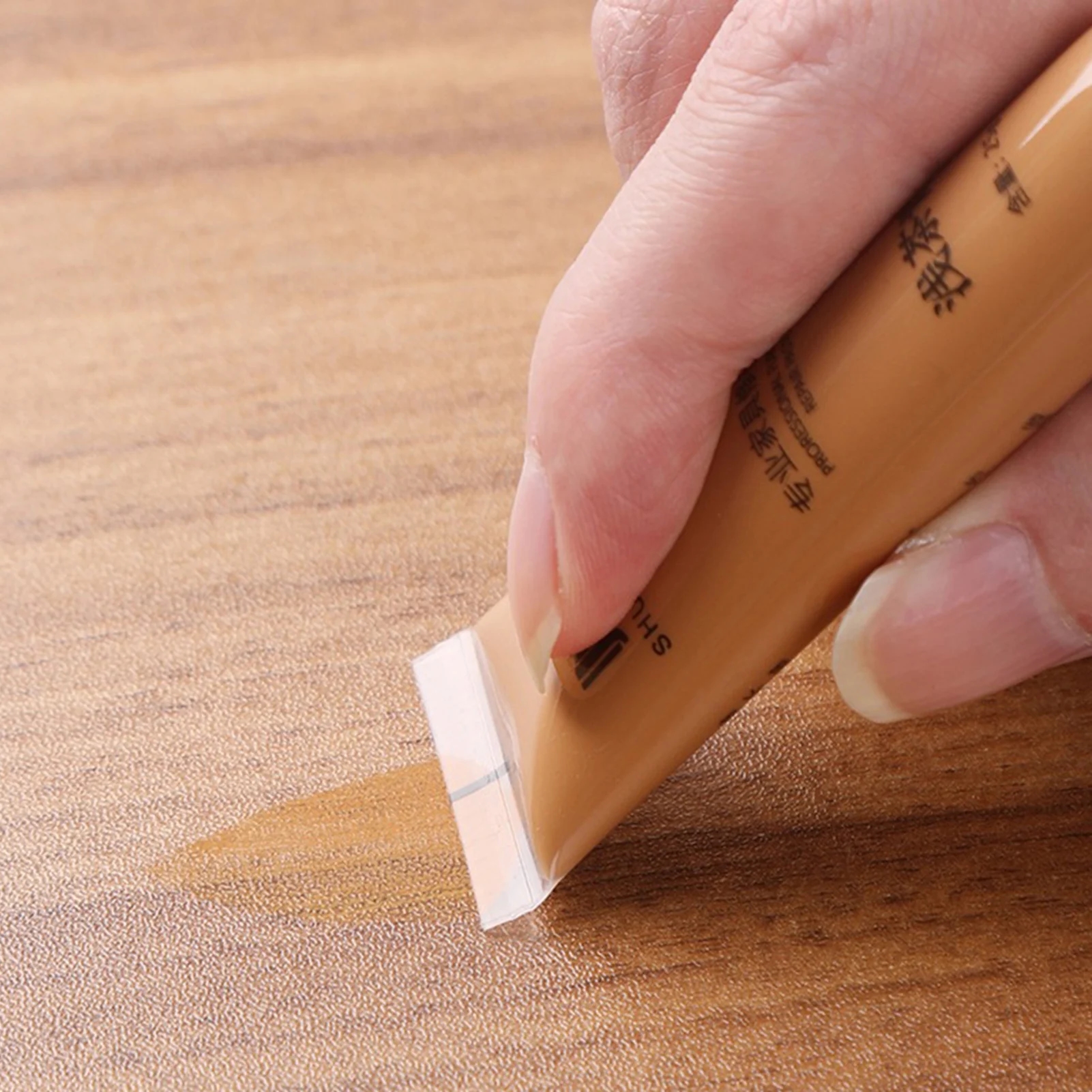 The process of applying repair paste to correct scratches and burns on wooden products