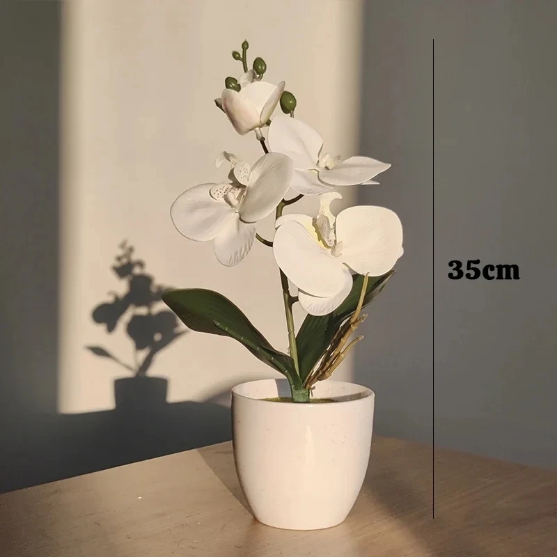 Artificial bonsai orchid on a bedside table in a bedroom