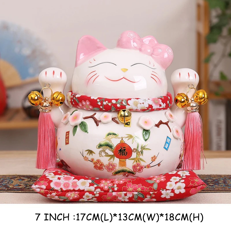 Close-up of a ceramic statuette of Maneki-neko Cat with raised paw