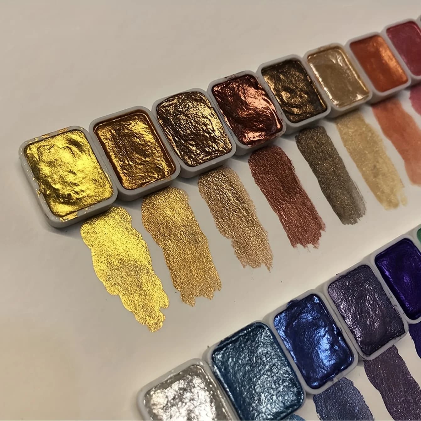 Set of iridescent pearlescent watercolor paints in a compact plastic box