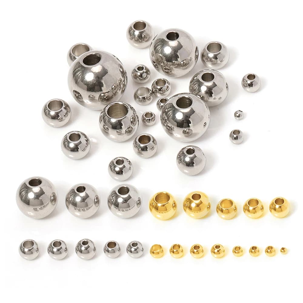 Round steel beads of various sizes on a white background