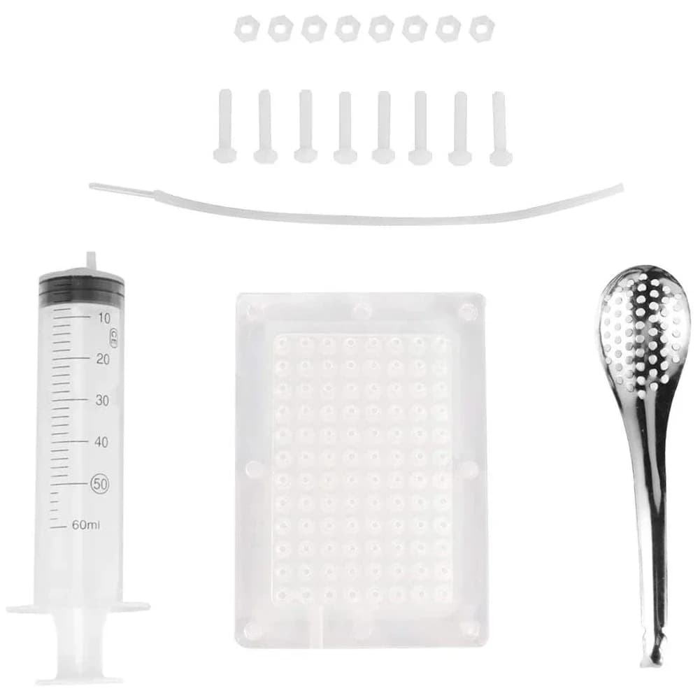 Close-up of a molecular cooking set with a spoon, dispenser, and other accessories